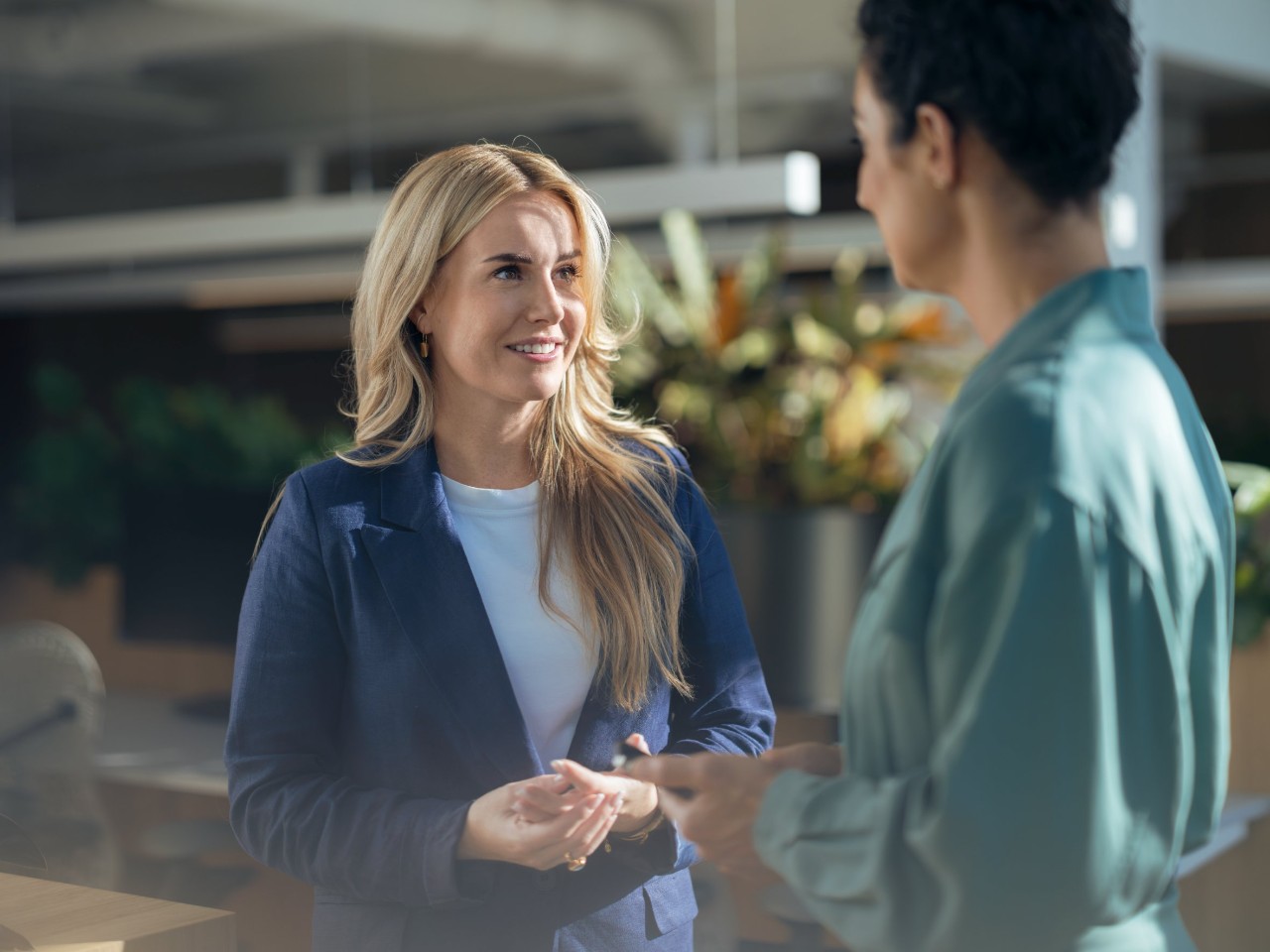 Woman smiling at person in front of her. 